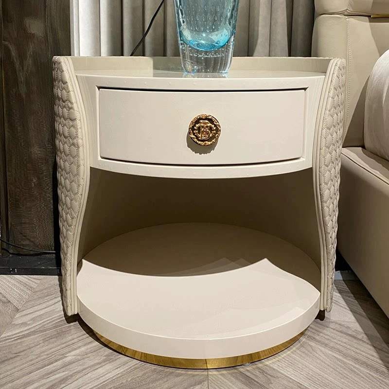 Ivory Oval Nightstand, Lacquered Bedside Table with Upholstered Side Panels, 1 Drawer, Open Shelf and Gold-Tone Base for Bedroom, Guest Room and Luxury Apartment
